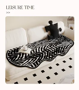 Modern irregular sofa cushion with black and white zebra pattern on a cream couch