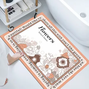 Top-down detail of a floral soft diatom mud bathroom mat by a bathtub