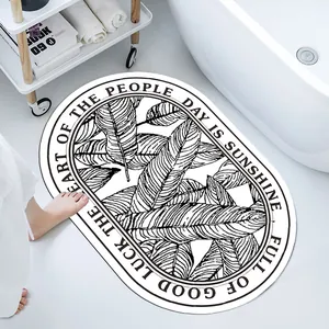 Detail of oval diatom mud bathroom mat with tropical leaf pattern and anti-slip texture