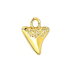 Detailed view of a gold-plated shark tooth pendant for DIY jewelry making
