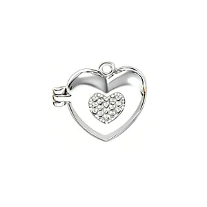 Detailed view of heart-shaped silver locket with interior stone-encrusted heart motif