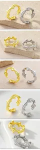 Detailed view of gold and silver plated thorn rings with an adjustable open band