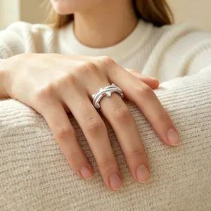 Unisex silver thorn design adjustable open ring shown on hand with cozy white sweater