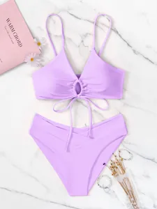 Dettaglio di un set bikini color lavanda con anello decorativo e slip a vita alta