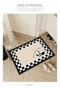 Minimalist panda print entrance doormat with checkerboard border in home hallway.