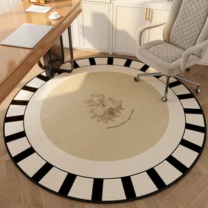 Elegant vintage round rug featuring a floral center and a black and white border