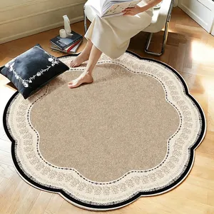 A close-up view of a vintage French-style scalloped rug in a warm living room setting