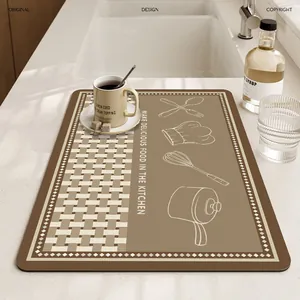 Absorbent kitchen drying mat with chef icons for coffee machines and countertops.