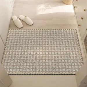 Close-up of checkered silk loop entryway mat displayed on a light wooden floor setting