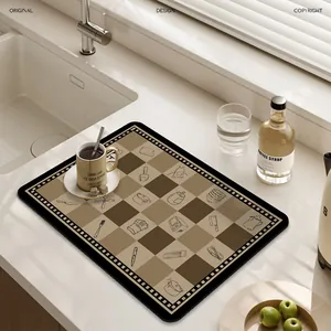 Checkered kitchen draining mat with tool icons on a white countertop decor
