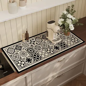 Detailed view of black and white tile pattern absorbent kitchen mat on countertop