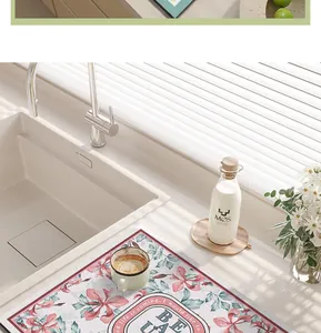 Close-up of floral PVC leather kitchen drying mat on a countertop next to a sink