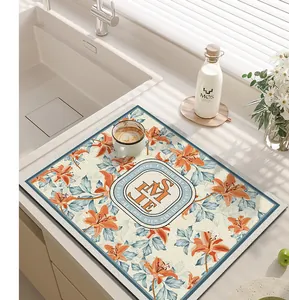 Elegant floral pattern kitchen draining mat placed on a modern countertop near a sink