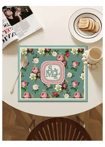 Top view of a floral printed waterproof leather placemat on a stylish modern dining table