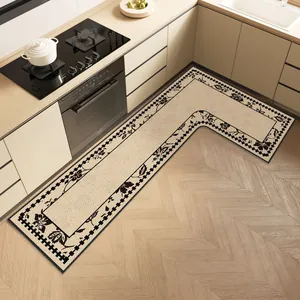 Elegant L-shaped woven linen kitchen mat with black floral pattern on wood floor