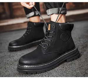 Detailed view of black leather high-top work boots featuring thick platform and side logo.