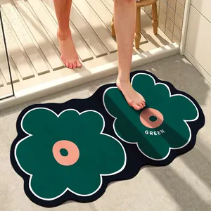 Close-up detail of dark green flower shaped absorbent bathroom mat for doorway safety