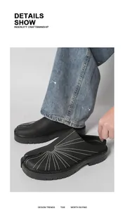 Detailed view of the split-toe design and contrast stitching on black leather mules.