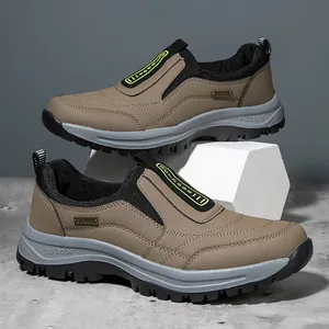 Detail view of men's brown slip-on outdoor shoes with durable thick soles and sport labels.