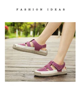 Detail shot of purple and white hollow-out closed-toe sandals with thick rubber soles.