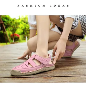 Close-up of stylish pink hollow-out breathable leather sandals worn by a model on a deck