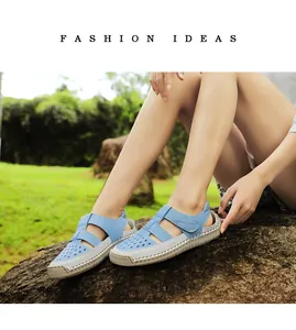 Fashionable light blue and beige hollow-out sandals shown in an outdoor lifestyle setting