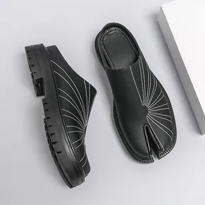 Stylish black leather tabi mules featuring white radial stitching and thick durable soles
