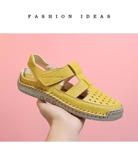 Detailed view of yellow hollow-out closed-toe sandal showing breathable hole pattern