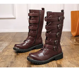 Detailed view of brown retro motorcycle tall boots with multiple buckle straps.