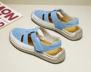 Detailed view of women's breathable blue and white hollowed-out closed-toe sandals