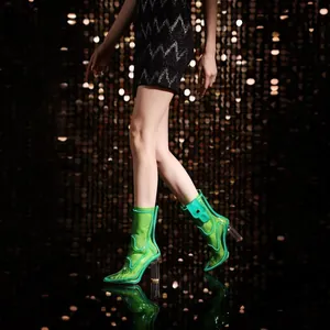 Glowing green transparent ankle boots with chunky clear heels for catwalk stage lighting