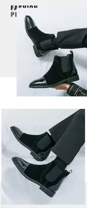 Detailed view of men's black Chelsea boots featuring leather and suede patchwork design