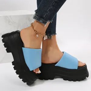 Close-up detail of light blue fashion platform slide sandals with a thick black lug sole