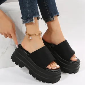 Stylish women's black platform slide sandals featuring chunky serrated sole detail