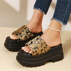 Close-up detail of stylish leopard print platform sandals with thick black lug soles