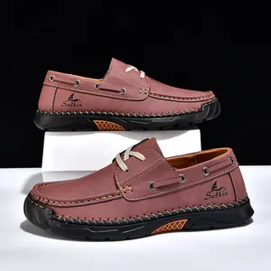 Detailed side view of brown men's casual loafers with contrast stitching and brand logo