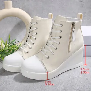 Close-up showing heel height of off-white high-top wedge canvas sneakers for women