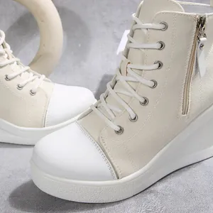 Close-up of women's high-top wedge canvas shoes with side zipper and white platform