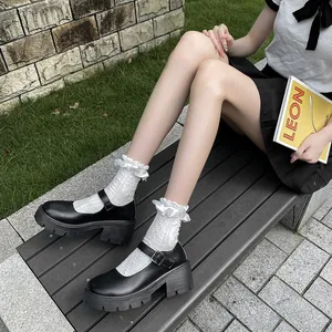Detailed side view of black platform Mary Janes with white lace socks on a bench