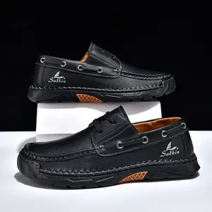 Close-up of black PU leather men's casual shoes featuring detailed hand-stitching