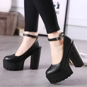 Close-up detail of black matte platform pumps with high block heel and ankle strap
