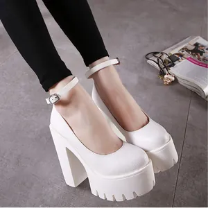 Close-up of white platform pumps featuring chunky high heels and ankle strap detail.