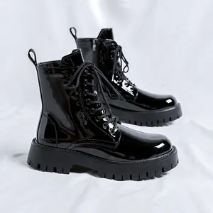 Shiny black patent leather combat boots for men featuring a heavy duty lug sole design