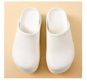 Top view of professional white surgical clog slippers on a neutral beige background