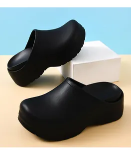 Detail view of black surgical clogs for doctors on professional studio setup