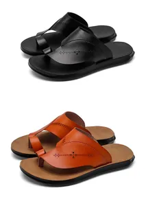 Detail of men's PU leather flip-flops in black and orange with decorative patterns