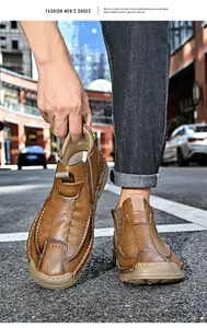 Stylish men's brown leather Martin boots with chunky sole and hand-stitched detailing