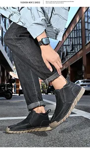 Close-up detail of men's black leather Martin boots with a thick anti-slip sole on street.