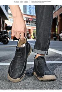 Detailed shot of black men's Martin boots with contrast stitching and thick sole