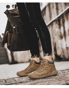 Detailed view of brown high-top outdoor hiking boots with non-slip rubber soles.